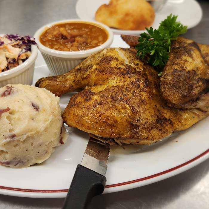 Baked half chicken with side of mashed potatoes served at The Hideout restaurant and bar in Stacy, MN