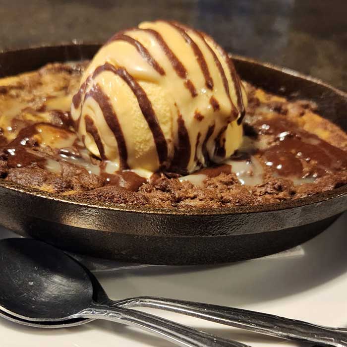 Cookie brownie brookie cast iron dessert served at The Hideout restaurant and bar in Stacy, MN