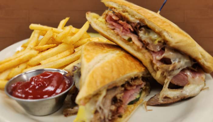 Pressed Cuban sandwich served at The Hideout restaurant and bar in Stacy, MN Pressed Cuban sandwich served at The Hideout restaurant and bar in Stacy, MN