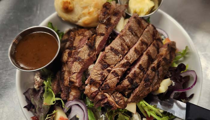 Grilled steak salad served at The Hideout restaurant and bar in Stacy, MN Grilled steak salad served at The Hideout restaurant and bar in Stacy, MN